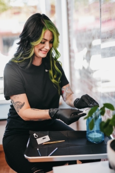 tattoo artist filling bottle